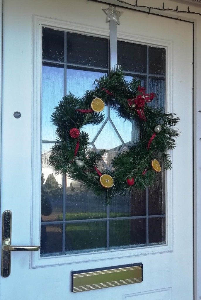 A Christmas wreath attached to a door